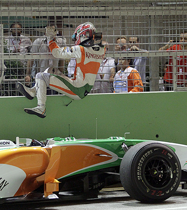 Force India's Vitantonio Liuzzi climbs off the track after retiring from the Singapore GP