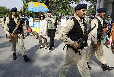 Indian security personnel patrol a shopping arcade ahead of Commonwealth Games in New Delhi
