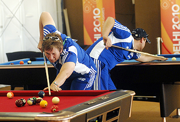 Team members from Scotland play snooker inside the Commonwealth Games Village