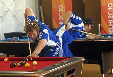 Team members from Scotland play snooker inside the Commonwealth Games athletes village
