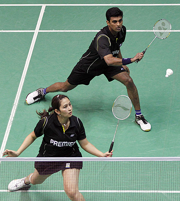 V Diju and Jwala Gutta play a return shot during their mixed doubles match at the 2010 Badminton World Championships in Paris