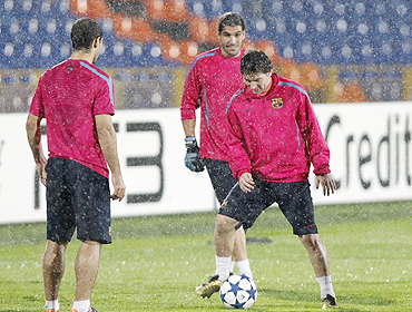 Lionel Messi (right) with teammates at a training session