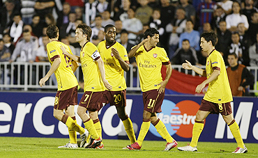 Arsenal's Sebastien Squillaci (left) celebrates with his teammates after scoring against Partizan Belgrade