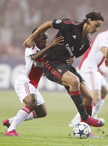Ajax Amsterdam's Vurnon Anita (left) challenges AC Milan's Zlatan Ibrahimovic during their Champions League Group G match