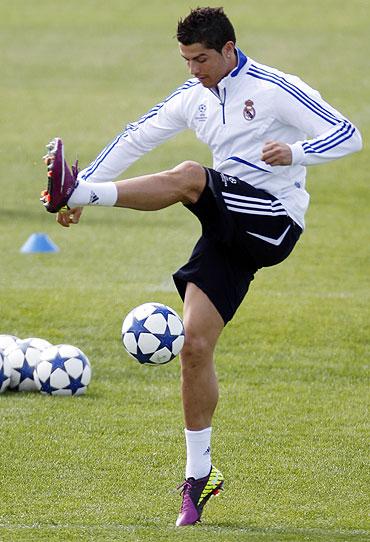 Real Madrid's Cristiano Ronaldo juggles a ball during a training session at the Valdebebas training grounds outside Madrid