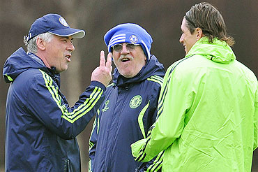 Chelsea manager Carlo Ancelotti (left) gestures as he speaks to Fernando Torres (right) at a training session