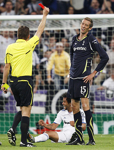 Tottenham Hotspur's Peter Crouch (right) receives the matching orders from referee Felix Brych of Germany