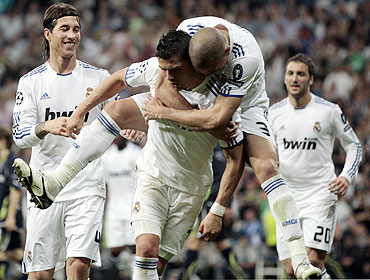 Real Madrid's Cristiano Ronaldo (centre) is congratulated by teammates Pepe and Sergio Ramos (left) after scoring against Tottenham Hotspur