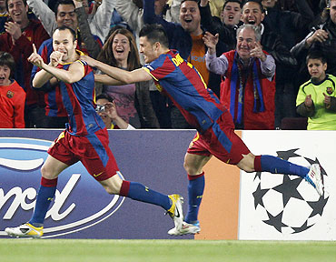 Barcelona's Andres Iniesta (left) celebrates with team-mate David Villa after scoring against Shakhtar Donetsk