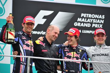 Race winner Sebastian Vettel (2nd right) celebrates on the podium with second placed team mate Mark Webber (left) and Red Bull Racing and Red Bull Racing Chief Technical Officer Adrian Newey (2nd left) and third placed Nico Rosberg (right)  following the Malaysian GP last year.