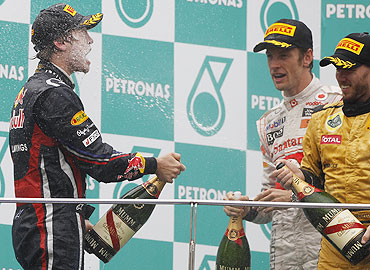 Sebastian Vettel (left) celebrates with Jenson Button and Nick Heidfeld on the podium