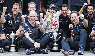 Red Bull's Sebastian Vettel (centre) celebrates with his team after winning the Malaysian F1 Grand Prix on Sunday