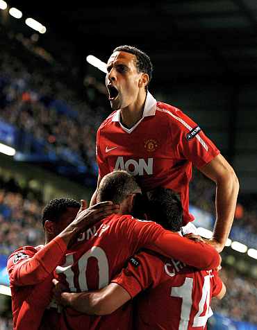 Manchester United players celebrate after scoring