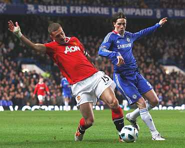 Chelsea's Fernando Torres is challenged by Manchester United's Vidic
