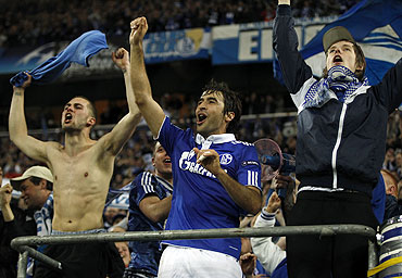 Raul Gonzalez (centre) celebrates with Schalke 04 supporters after the match against Inter