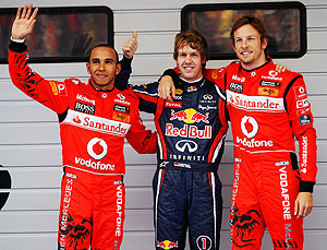 Red Bull's Sebastian Vettel (centre) celebrates with McLaren's Jenson Button (right) ans Lewis Hamilton after taking pole in China on Saturday