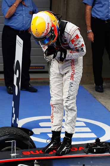 McLaren's Lewis Hamilton reacts after winning the Chinese Formula One Grand Prix at the Shanghai International Circuit
