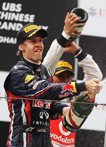 Red Bull's Sebastian Vettel celebrates after the Chinese Formula One Grand Prix at the Shanghai International Circuit