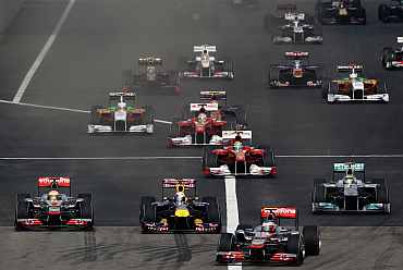 Cars come out of their starting grid during the Chinese Formula One Grand Prix at the Shanghai International Circuit