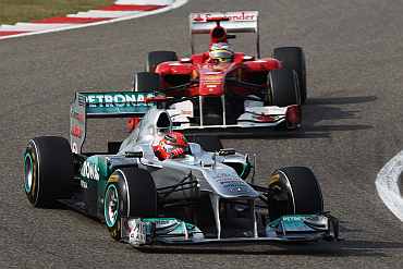 Michael Schumacher drives ahead of Fernando Alonso during the Chinese Grand Prix