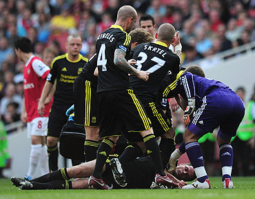 Liverpool players surround Jamie Carragher after falling unconscious