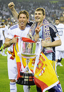 Real Madrid's captain and goalkeeper Iker Casillas (right) and teammate Sergio Ramos celebrate with the King's Cup trophy