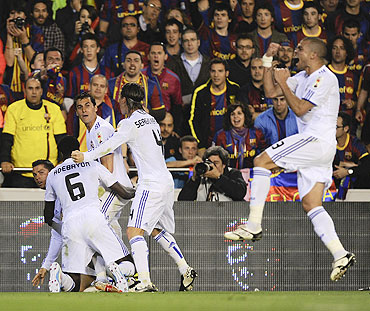 Real Madrid'S Cristiano Ronaldo (left) celebrates with teammates after scoring