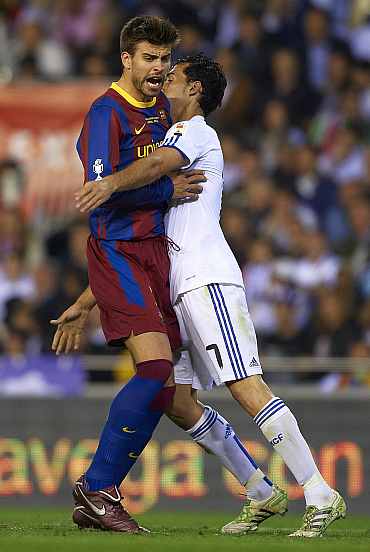Gerrad Pique in action against Real Madrid player in El Clasico