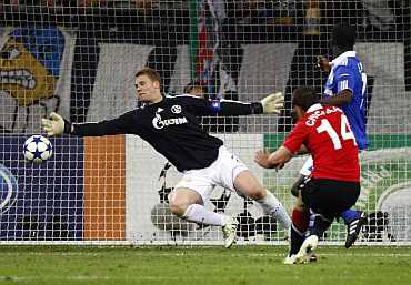 Schalke goalkeeper Neuer makes a save during their Champions League semi-final first leg match against Man United