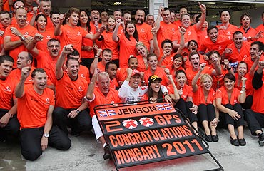 McLaren's Jenson Button celebrates his victory with teammembers in the Hungarian F1 Grand Prix at the Hungaroring circuit on Sunday