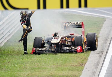 Renault's Nick Heidfeld jumps away from his burning car during the Hungarian GP at the Hungaroring circuit