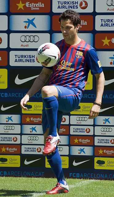 Cesc Fabregas poses for the photographers during his presentation at Camp Nou