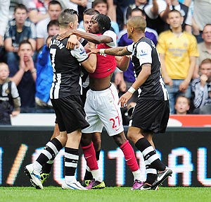 Arsenal's Gervinho (right) confronts Newcastle's Joey Barton shortly before being shown the red card by referee Peter Walton