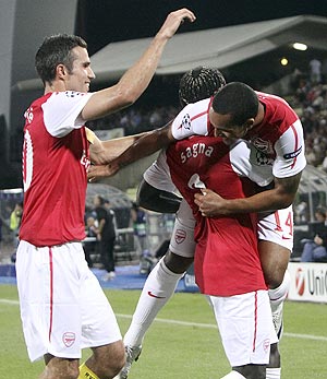 Arsenal's Theo Walcott (right) celebrates with teammates Robin van Persie (left) and Bacary Sagna (centre) after scoring against Udinese 