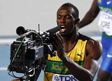 Usain Bolt looks into a TV camera after winning his men's 100 metres heat at the IAAF World Athletics Championships in Daegu