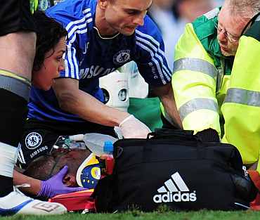 Didier Drogba of Chelsea receives treatment after a collision with goalkeeper John Ruddy of Norwich City