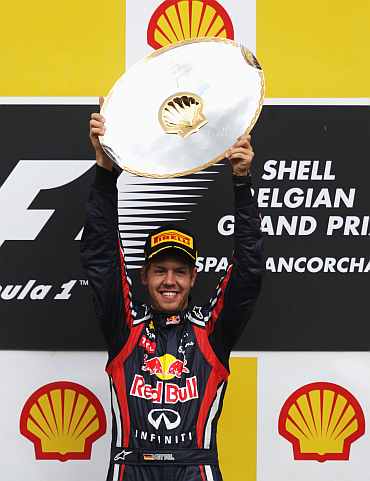 Sebastian Vettel celebrates on the podium after winning the Belgian Formula One Grand Prix
