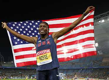 Brittney Reese of the U.S. holds her national flag as she wins the women's long jump final at the IAAF World Championships in Daegu