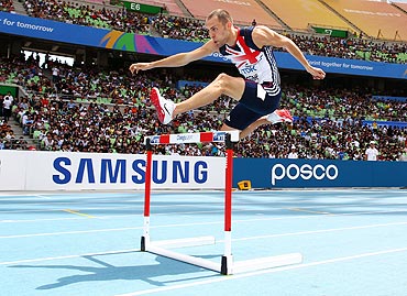 David Greene of Great Britain competes in the men's 400 metres hurdles heats on Monday