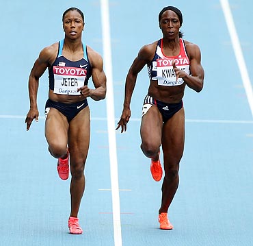 Carmelita Jeter of United States and Jeanette Kwakye of Great Britain compete in the women's 100 metres heats on Sunday