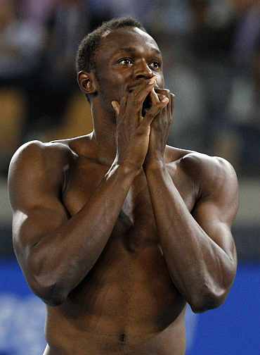 Usain Bolt reacts after being disqualified in the men's 100 metres final