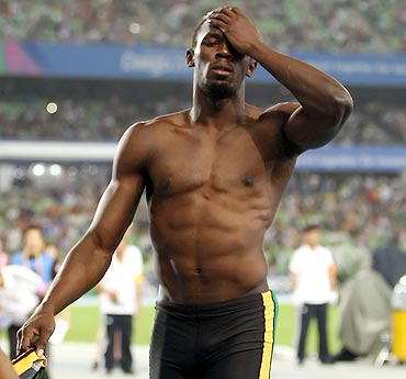 Usain Bolt shows his dejection after being disqualified for a false start