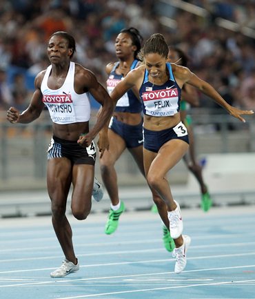 Amantle Montsho of Botswana and Allyson Felix of United States cross the finish line in the women's 400 metres final.