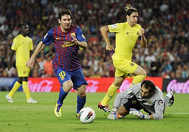 Lionel Messi runs past goalkeeper Diego Lopez to score his team's fourth goal