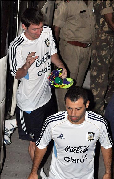 Lionel Messi and Javier Mascherano arrive for a practice session at the Yuba Bharati Krirangan in Kolkata on Wednesday