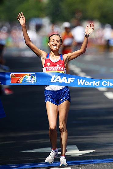 Gold medalist Olga Kaniskina of Russia celebrates as she crosses the finish line
