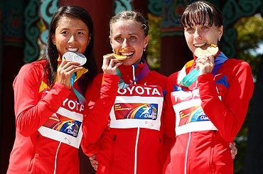 Silver medalist Hong Liu of China, gold medalist Olga Kaniskina of Russia and bronze medalist Anisya Kirdyapkina of Russia on the podium