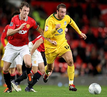 Glenn Murray of Crystal Palace competes with Jonny Evans of Manchester United