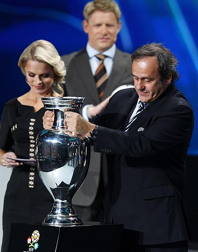 Michel Platini, UEFA President places the trophy down during the UEFA EURO 2012 Final Draw Ceremony