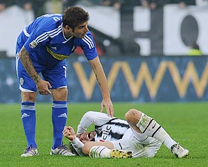 Alessandro Del Piero of Juventus FC lies injured on the pitch as Adrian Mutu checks on him during their Serie A match on Sunday